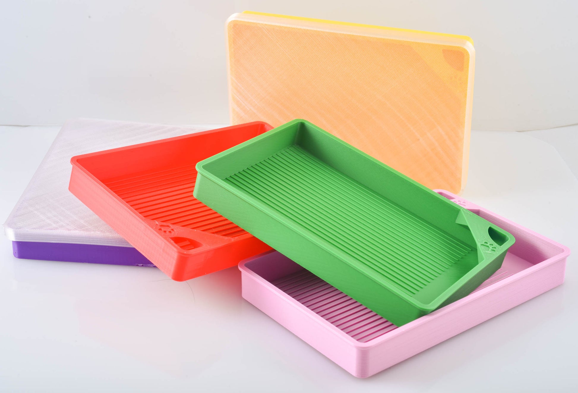 Red, Green, Yellow, Pink, and Purple diamond painting trays stacked up showcasing lids.