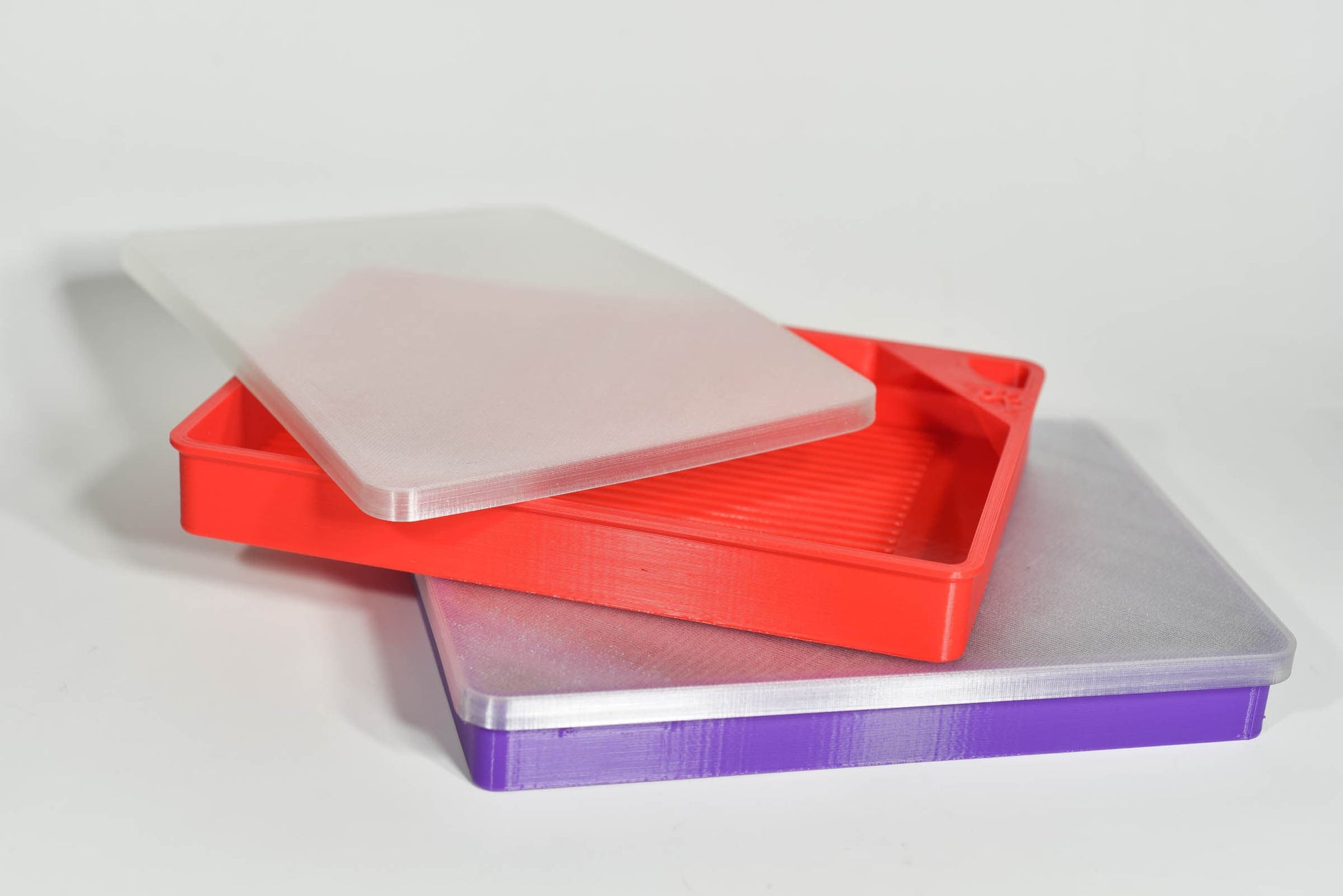 Red and purple tray showcasing our flexible lid stays tight